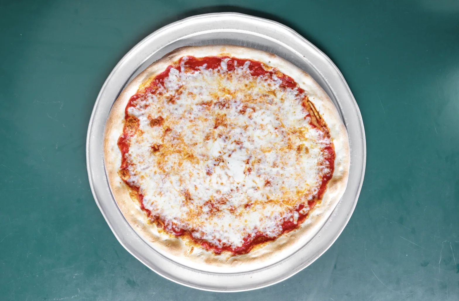 Classic cheese pizza on a metal tray