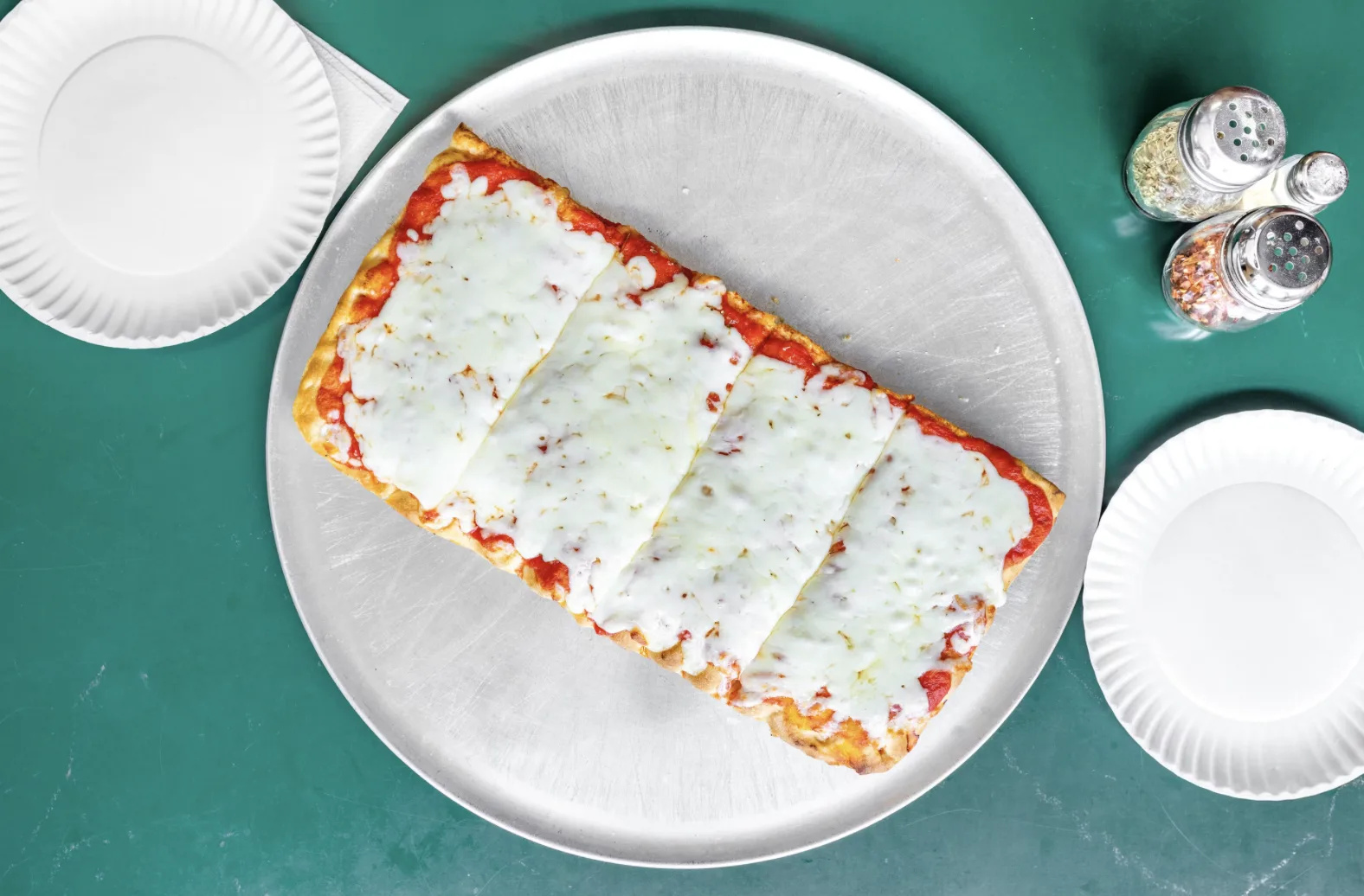 Sicilian-style pizza with melted mozzarella